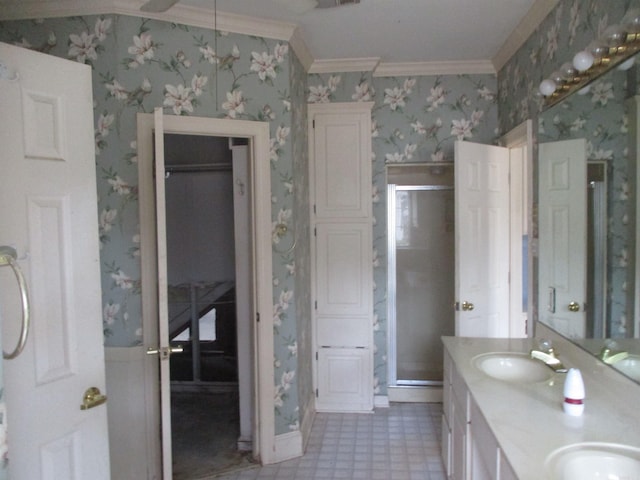 bathroom with vanity, an enclosed shower, and ornamental molding