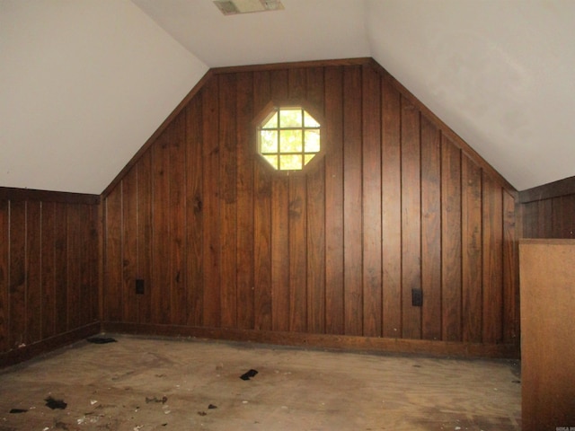 bonus room featuring wooden walls