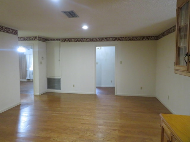 spare room featuring light wood-type flooring