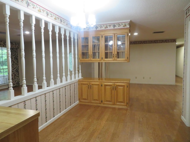 interior space with light hardwood / wood-style floors and a notable chandelier