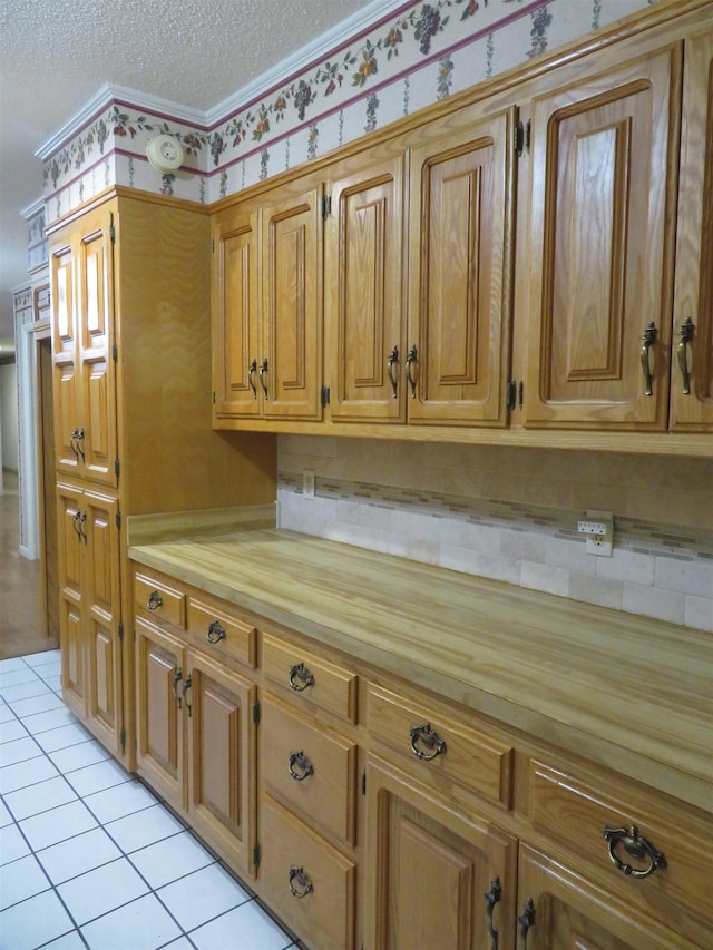 kitchen with light tile patterned floors and a textured ceiling