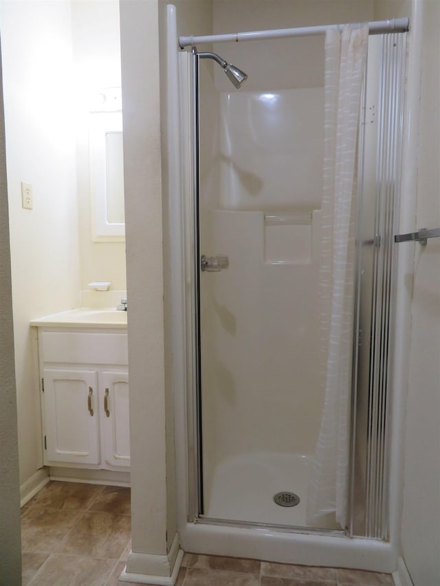 bathroom featuring vanity and a shower