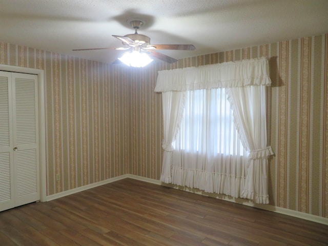 unfurnished room featuring ceiling fan and dark hardwood / wood-style flooring