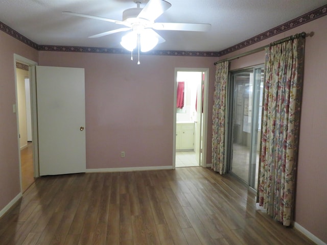 empty room with wood-type flooring and ceiling fan