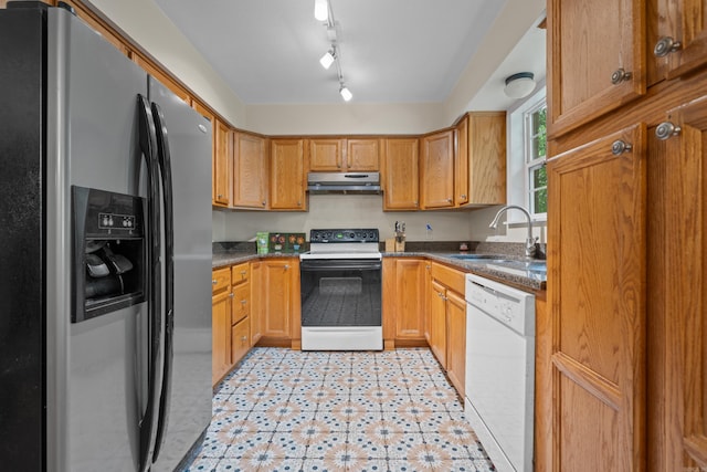 kitchen featuring rail lighting, sink, and white appliances