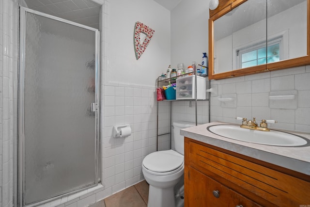 bathroom featuring tile walls, an enclosed shower, vanity, tile patterned floors, and toilet