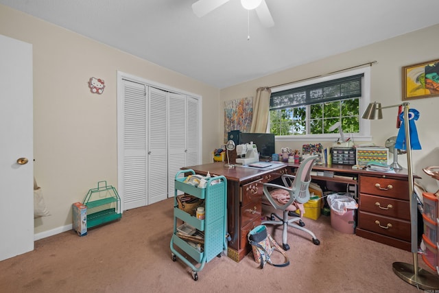 home office featuring light carpet and ceiling fan