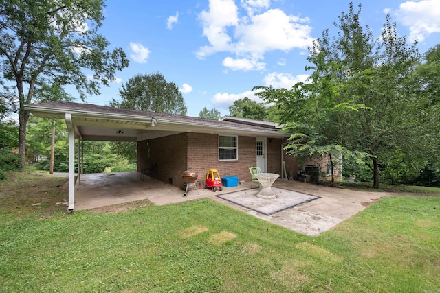 back of property featuring a yard and a patio