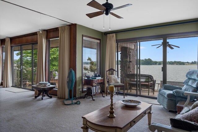 living room featuring carpet and a water view