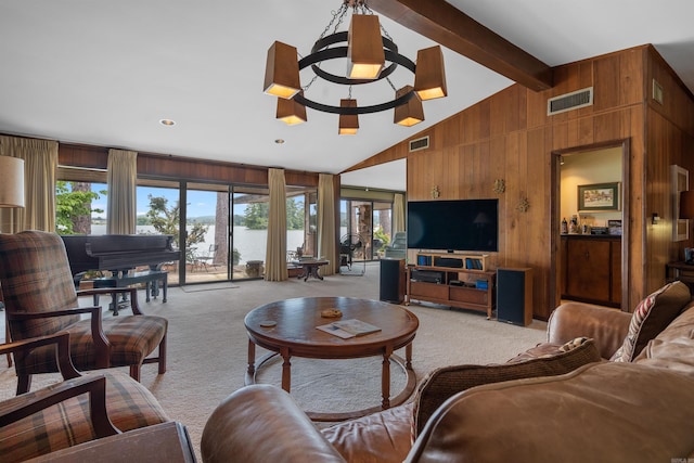 carpeted living room featuring a healthy amount of sunlight, lofted ceiling with beams, and wooden walls