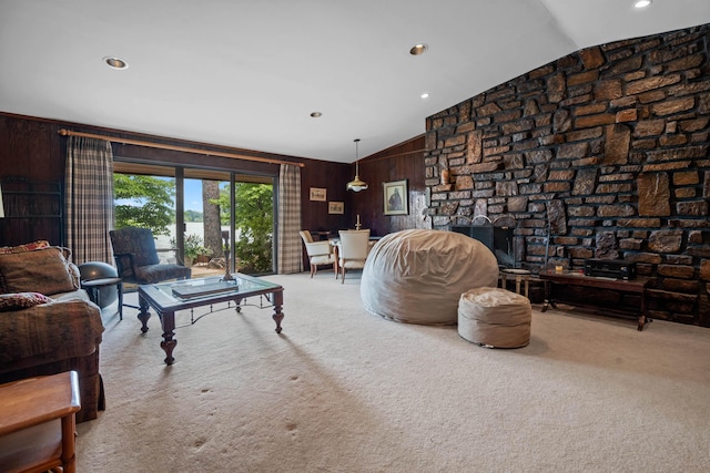 carpeted living room featuring vaulted ceiling and wooden walls