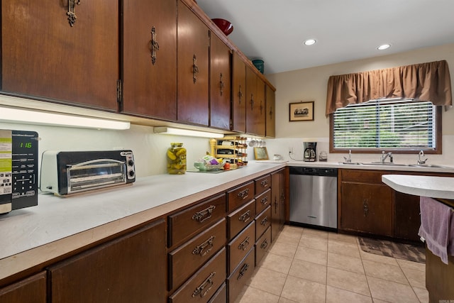 kitchen with sink, stainless steel dishwasher, and light tile patterned flooring