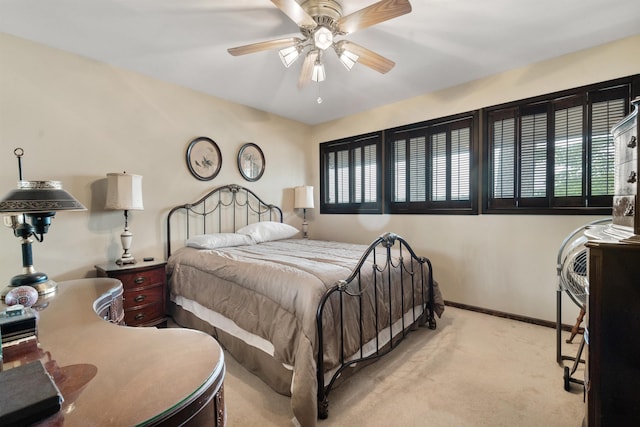 bedroom with ceiling fan and light colored carpet