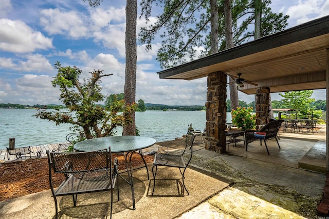 view of patio featuring a water view and ceiling fan