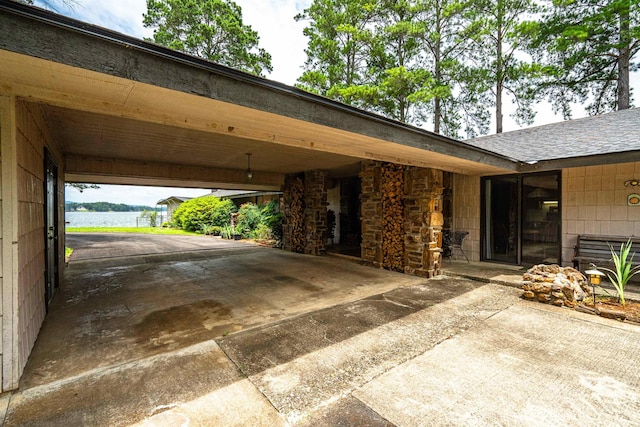 exterior space featuring a water view and a carport