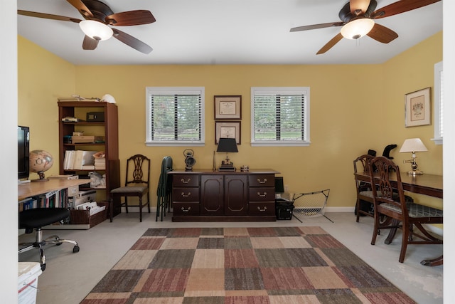 carpeted office featuring ceiling fan