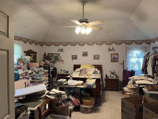 carpeted bedroom featuring ceiling fan and vaulted ceiling