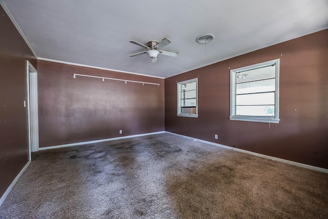 carpeted empty room featuring ornamental molding and ceiling fan