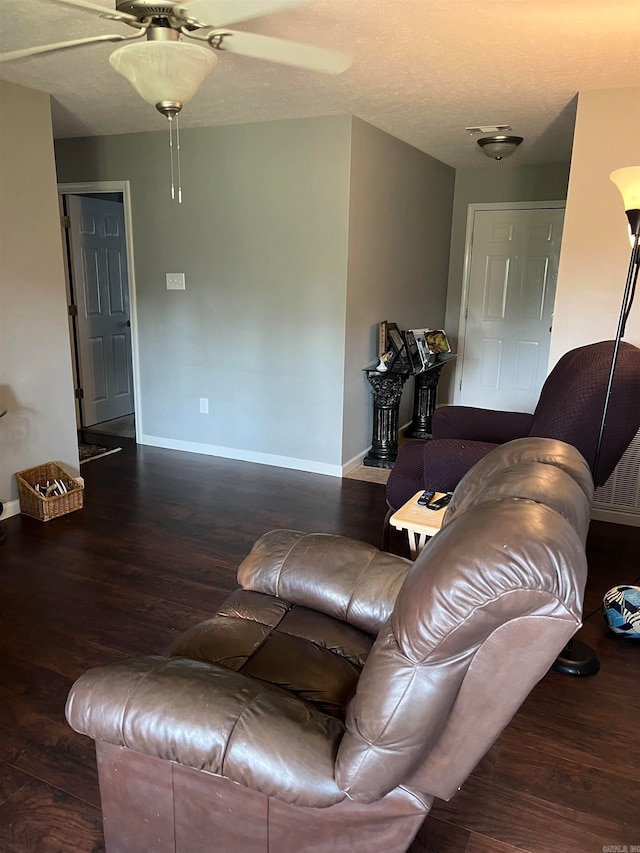 living room with ceiling fan and hardwood / wood-style flooring