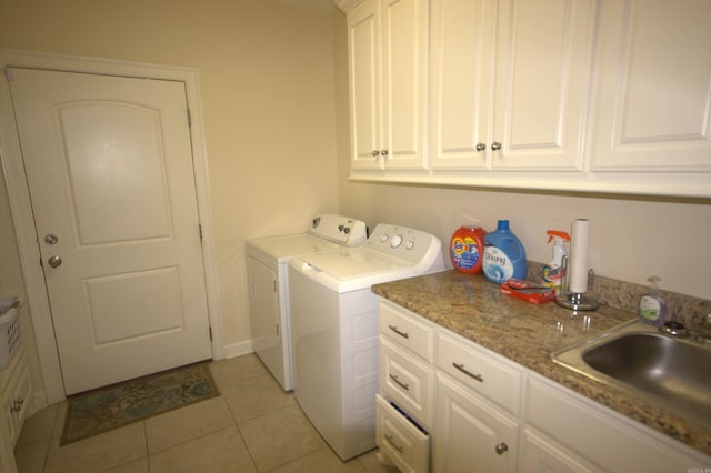 laundry room with cabinets, separate washer and dryer, light tile patterned flooring, and sink