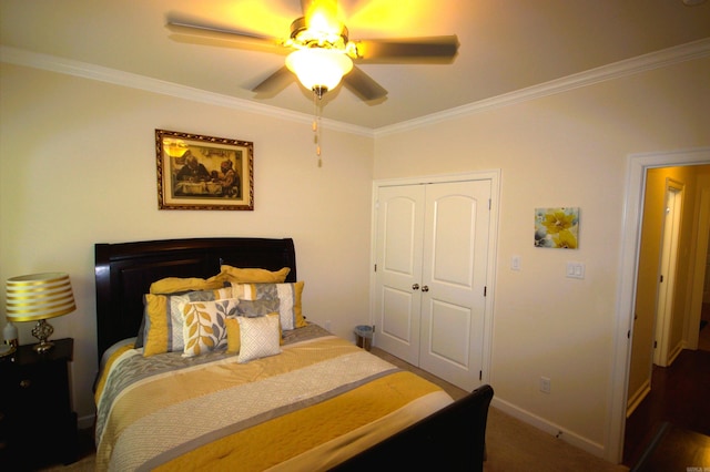 carpeted bedroom featuring a closet, ceiling fan, and crown molding