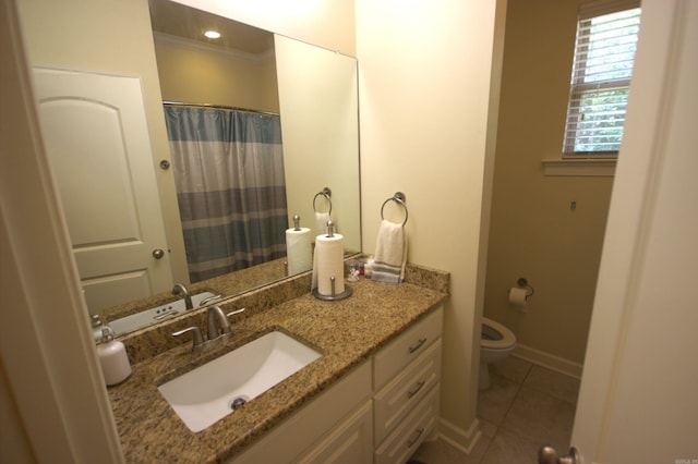 bathroom with tile patterned flooring, vanity, toilet, and crown molding