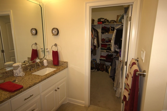 bathroom featuring tile patterned flooring and vanity