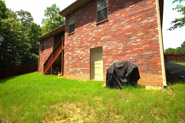 rear view of property featuring a lawn