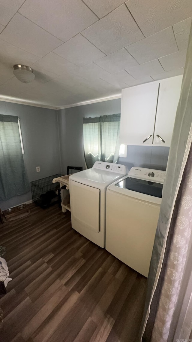 washroom featuring cabinets, dark hardwood / wood-style floors, and washer and dryer