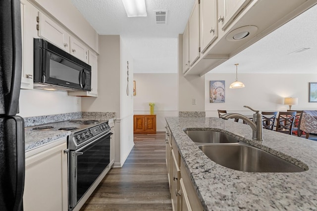 5371 Central Ave Unit L, Hot Springs, AR 71913 - kitchen featuring dark wood-type flooring, sink, pendant lighting, white cabinets, and range with electric stovetop