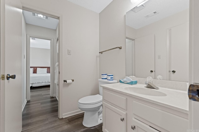 5371 Central Ave Unit L, Hot Springs, AR 71913 - bathroom featuring hardwood / wood-style floors, vanity, a textured ceiling, and toilet
