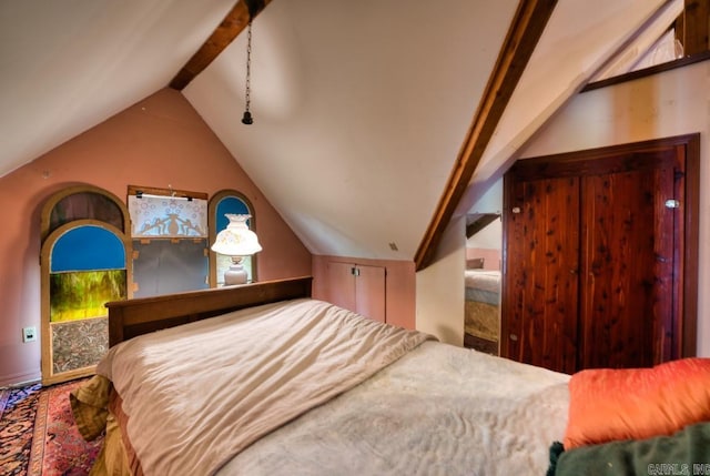 bedroom with vaulted ceiling with beams