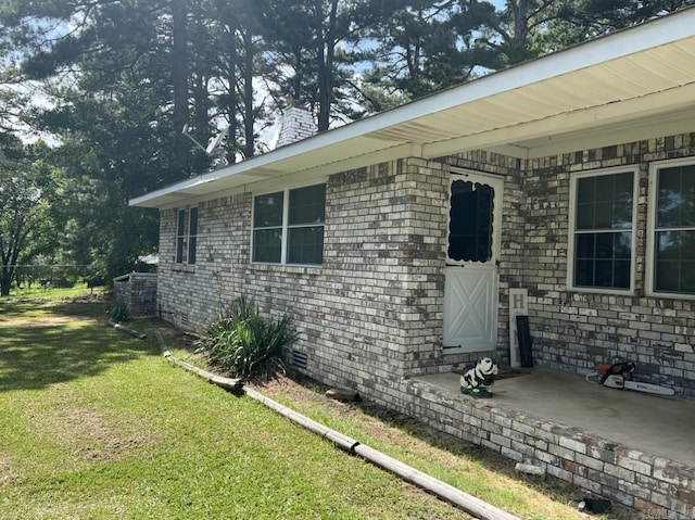 doorway to property with a yard