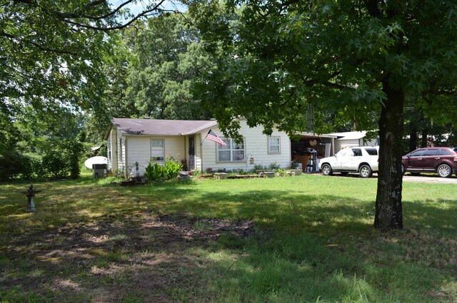 view of front facade with a front yard and a carport