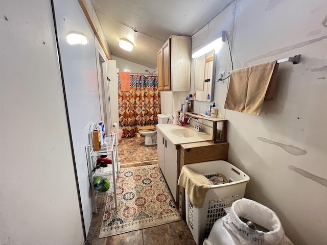 bathroom with vanity, curtained shower, toilet, and lofted ceiling