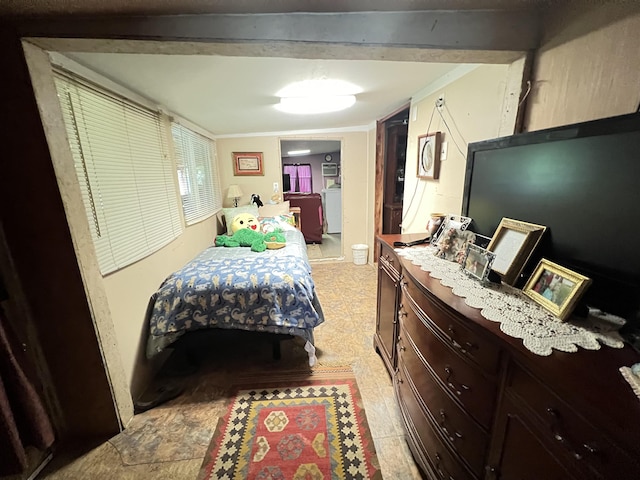 bedroom with washing machine and dryer and ornamental molding