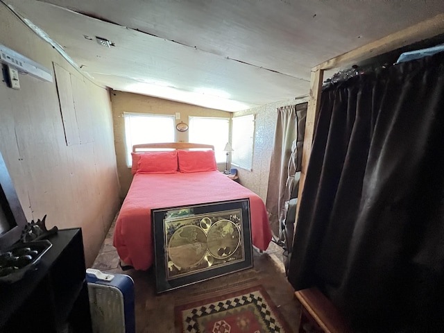 bedroom with wood-type flooring and lofted ceiling