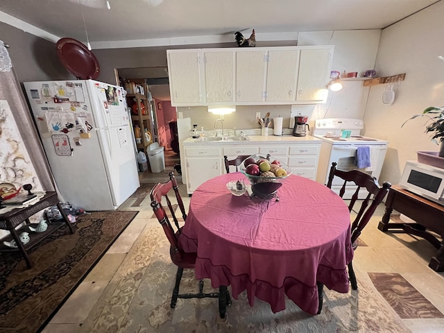 kitchen featuring white cabinetry, white appliances, and sink