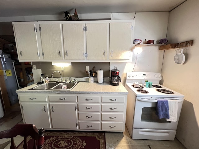 kitchen with light tile patterned flooring, sink, white cabinets, and electric stove