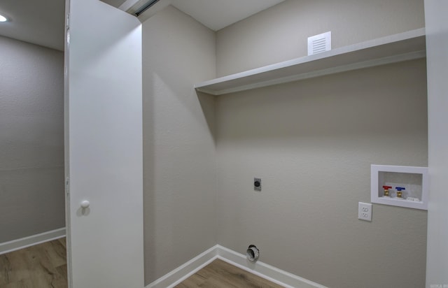 washroom featuring washer hookup, hookup for an electric dryer, and light hardwood / wood-style flooring