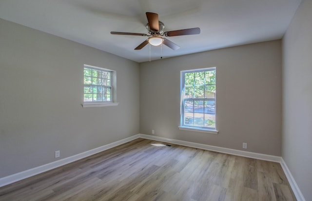 unfurnished room featuring ceiling fan, light wood-type flooring, and a wealth of natural light