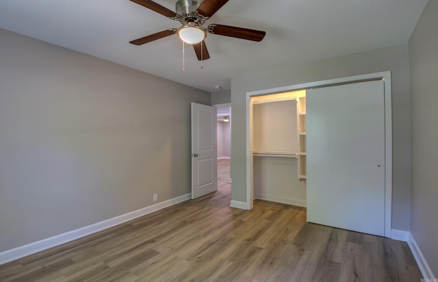 unfurnished bedroom featuring light hardwood / wood-style flooring, a closet, and ceiling fan