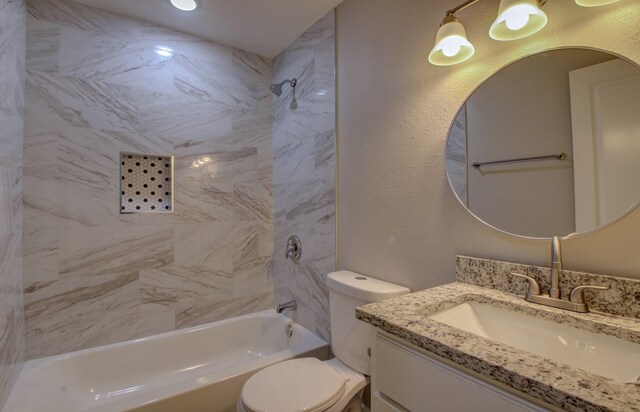 full bathroom with vanity, toilet, and tiled shower / bath combo