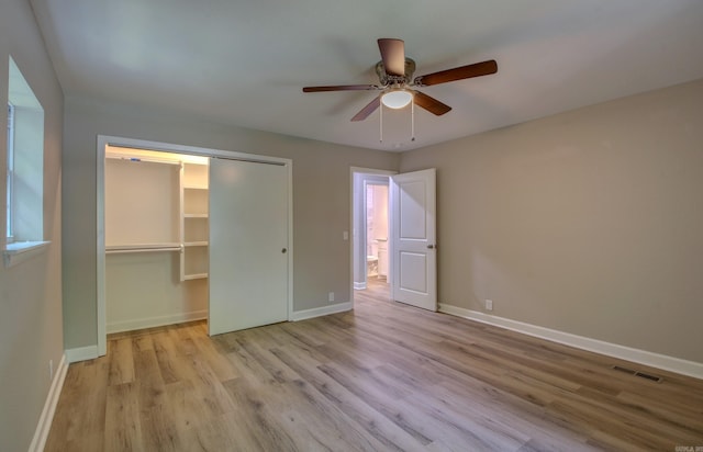 unfurnished bedroom with ceiling fan, a closet, and light hardwood / wood-style flooring