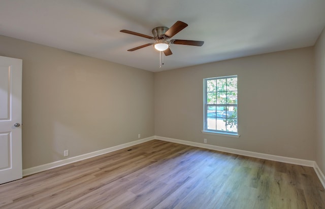 spare room with ceiling fan and light wood-type flooring