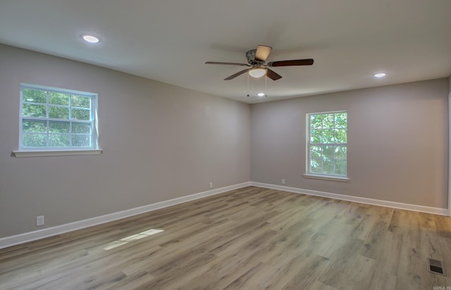 spare room with ceiling fan and light hardwood / wood-style floors