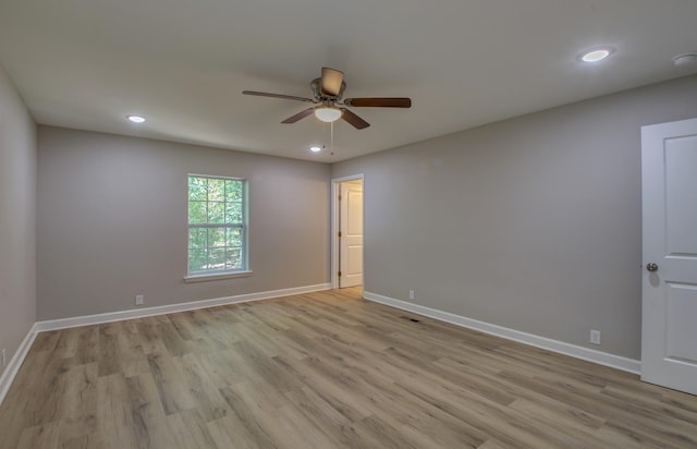 spare room with ceiling fan and light hardwood / wood-style flooring