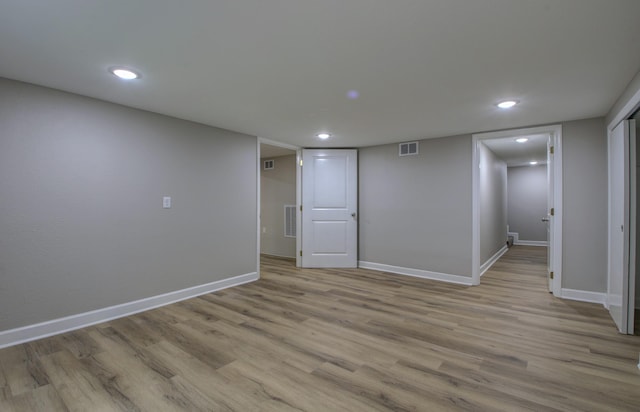 basement with light hardwood / wood-style floors