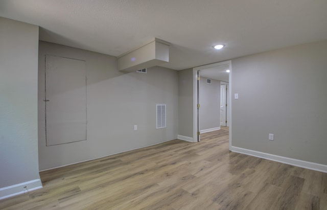 empty room featuring light hardwood / wood-style floors and a textured ceiling