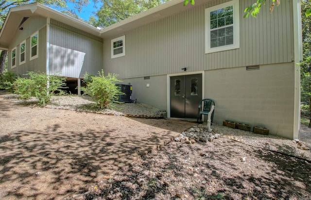 rear view of property with cooling unit